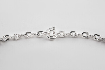 Silver bracelet with transparent stones. Beautiful jewelry with diamonds on a white background.