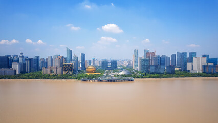 Naklejka premium Aerial View of Modern Cityscape by the River Under Clear Blue Sky