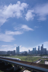 Modern Urban Landscape Featuring High-Speed Train and City Skyline