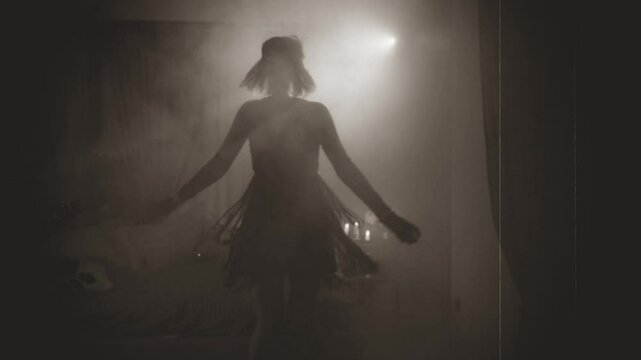 Old film 1920 style black white color, dark female silhouette dancing, sexy vintage dress waving retro lady young happy woman dancer at night club party have fun joy. room full smoke back light flare