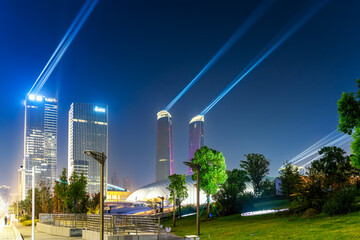 Stunning Urban Nightscape with Colorful Light Beams Illuminating Skyscrapers