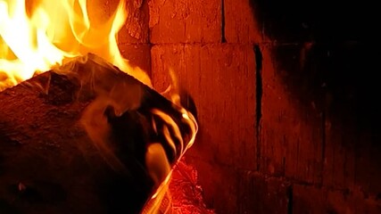 Video of a burning fireplace for warmth at night with space for text on the right