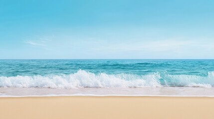 Obraz premium Scenic beach view with turquoise water and gentle waves against a clear sky.