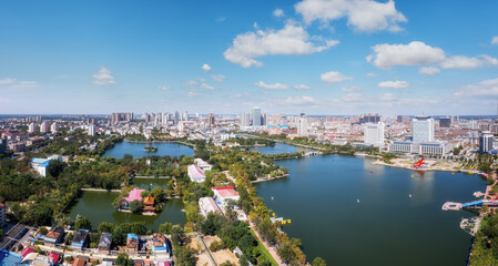Fototapeta premium Aerial View of a Serene Urban Landscape with Water Bodies and Cityscape