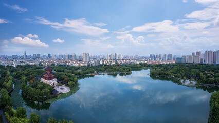 Panoramic View of a Serene Urban Lake with Lush Greenery