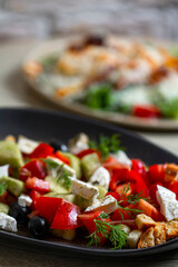 Greek salad with feta cheese, tomatoes, cucumbers, onions and croutons