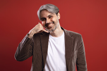 smiling man making a phone with his hand