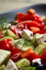 Greek salad with feta cheese, tomatoes, cucumbers, onions and croutons