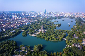 Fototapeta premium Aerial View of Cityscape with Lush Greenery and Serene Waterways