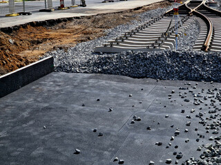 new and precise laying of tracks using leveling devices at the fork in two tram tracks. a layer of...