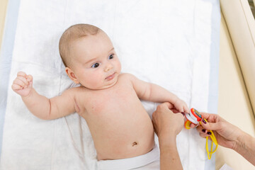 the pediatrician measures the pressure with a pulse oximeter for the baby