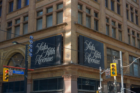exterior building facade and sign of Saks Fifth Avenue, a department store, located at 176 Yonge St in downtown Toronto, Canada
