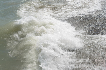 waves crashing upon waves at the edge of the lake