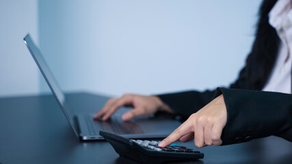 Income tax, Businesswoman calculates taxes using calculator and laptop. finance, tax, money, invest, banking, financial, fund.
