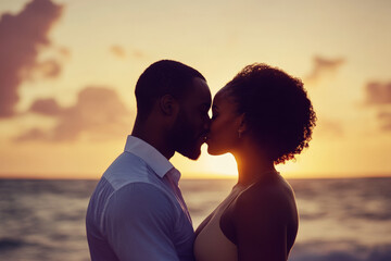 Fototapeta premium Young adult Black couple kissing each other, joyful expression of love, sunset background on the beach.