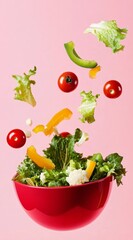 Vibrant salad ingredients dancing in mid-air above a red bowl against a soft pink backdrop, showcasing freshness and healthy eating