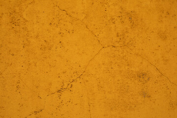 A textured yellow wall with subtle cracks