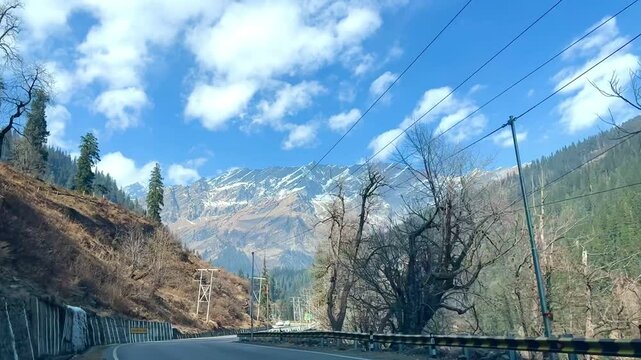 MANALI, INDIA - January 9, 2024: Beautiful journey between the snow mountains of Rohtang Pass in Himalayas.Snow mountains landscape.Winter ride between snow mountains.Beautiful snow mountains.