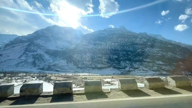 MANALI, INDIA - January 9, 2024: Beautiful journey between the snow mountains of Rohtang Pass in Himalayas.Snow mountains landscape.Winter ride between snow mountains.Beautiful snow mountains.