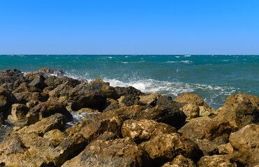 waves crashing on rocks on the Mediterranean coast