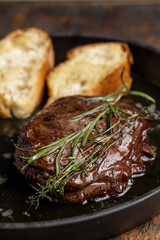 Grilled beef steak with rosemary and toasted baguette