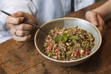 Tabbouleh salad in a bowl on a wooden table .quinoa salad