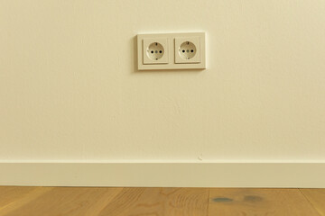 Two White Electrical Outlets on a Wall
