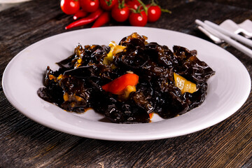Wood Ear Mushroom Salad on wood table. Chinese food. wooden sticks, soy sauce. China Sichuan Food