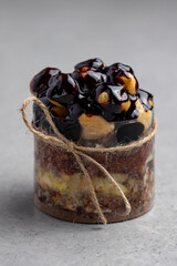 Chocolate cake with profiteroles on a gray background. Selective focus.