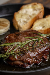 Grilled beef steak with rosemary and toasted baguette