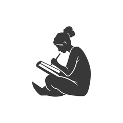 Silhouette of a woman writing in a notebook