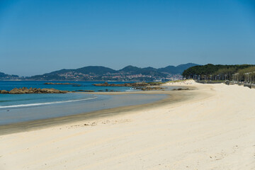View of Playa de Samil, the main beach of Vigo in Galicia in northwest Spain. Sunny day, crystal clear blue sea