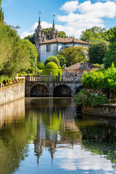 Beautiful lake with swans and flowering plants in the gardens of the Pazo de Oca, Galicia.