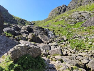 Lush Green Hills And Rocky Mountains: A Scenic Summer Landscape In Ireland