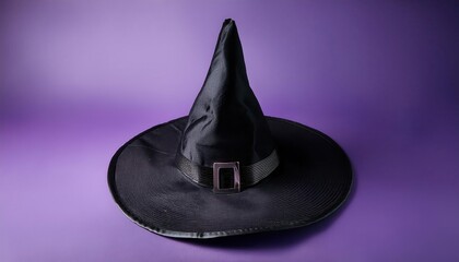 Fototapeta premium Black Witches' Hat with Silver Buckle on Purple Background. Pointed Wizard Hat for Halloween, Magic, and Witchcraft Themes, Perfect for Costumes, Spooky Decorations, and Fantasy Scenes