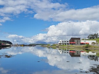Fototapeta premium Serene Waterscape: Little Waves And Cloud Reflections On A Scenic River
