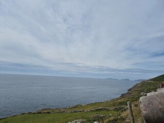 Serene River Landscape With Reflective Cloudy Skies And Gentle Waves