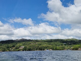Serene River Waterscape With Gentle Waves And Cloud Reflections