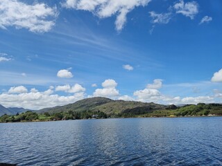 Serene River Waterscape With Gentle Waves And Cloud Reflections