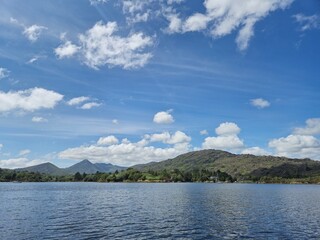 Serene River Waterscape With Cloud Reflections And Gentle Waves