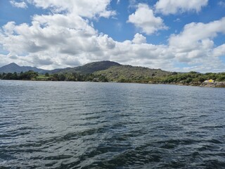Tranquil River Reflection: A Serene Waterscape Of Nature And Clouds