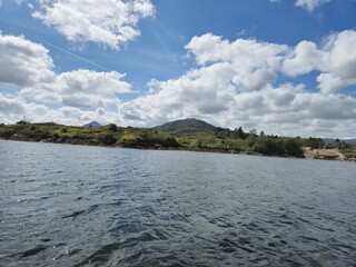 Tranquil Waterscape: Reflective Clouds Over Gentle Waves