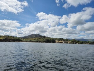 Scenic Waterscape: Gentle Waves Reflecting Clouds