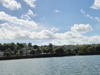 Serene River Waterscape With Reflective Clouds And Gentle Waves