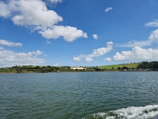 Serene River With Cloud Reflections And Gentle Ripples