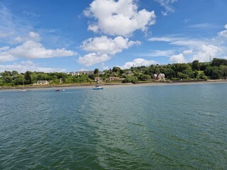 Tranquil River Waterscape With Cloud Reflections And Gentle Ripples