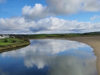 Serene River Waterscape With Little Waves And Cloud Reflections