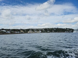 Tranquil Waterscape: Little Waves And Reflections Under A Cloudy Sky