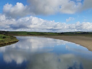 Tranquil River Waterscape With Little Waves And Cloud Reflections