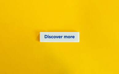 Discover More Phrase. Text on Block Letter Tile on Yellow Background. Minimal Aesthetic.